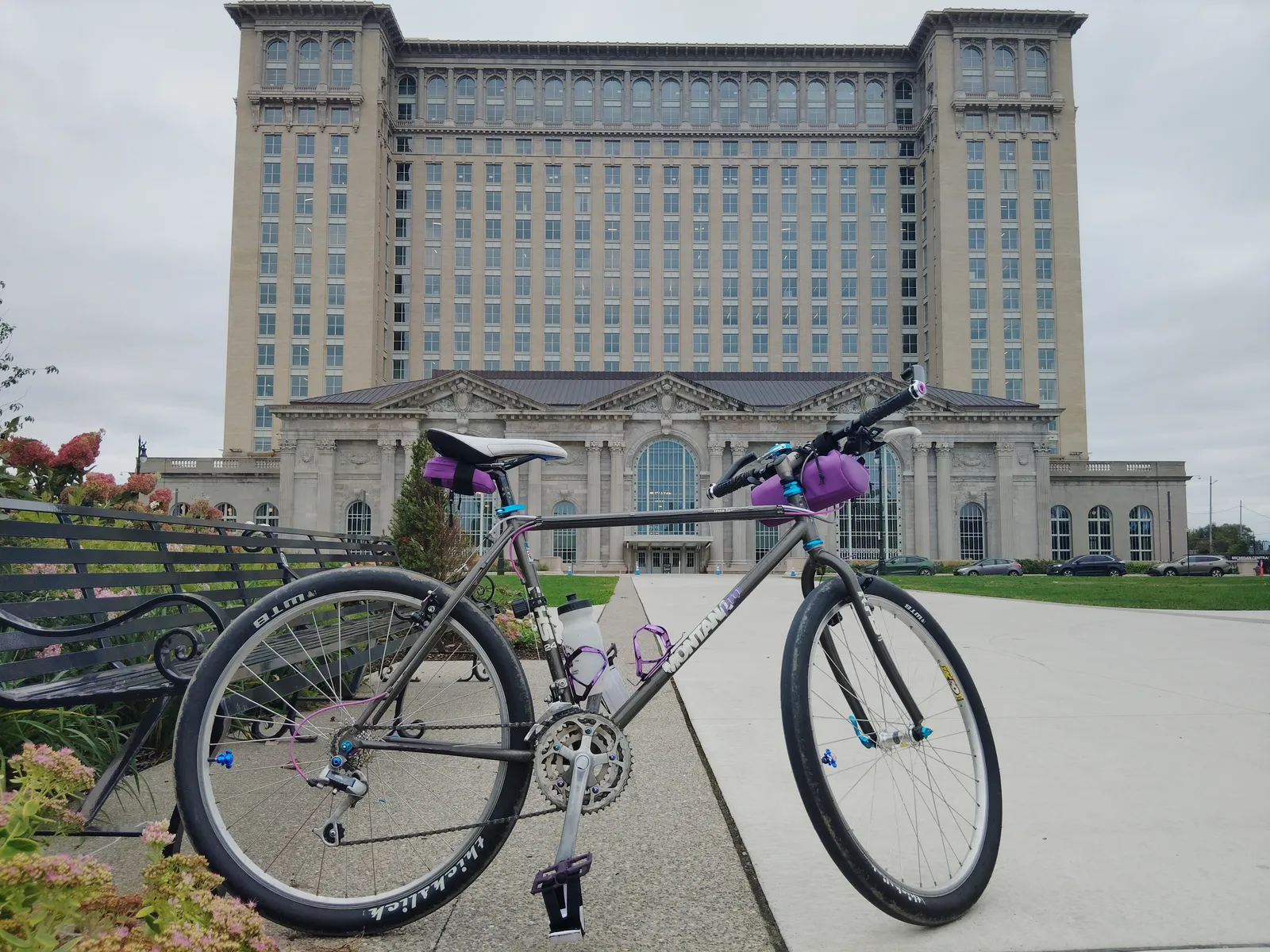 Silver bicycle with purple and turquoise components outside Michigan Central
