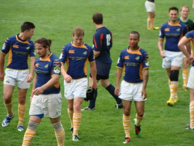 Players in blue and yellow walking together